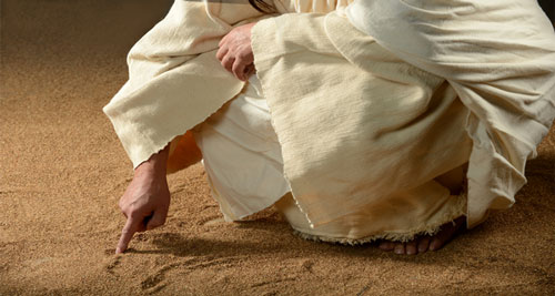 يسوع ينحني ويكتب على الرمل